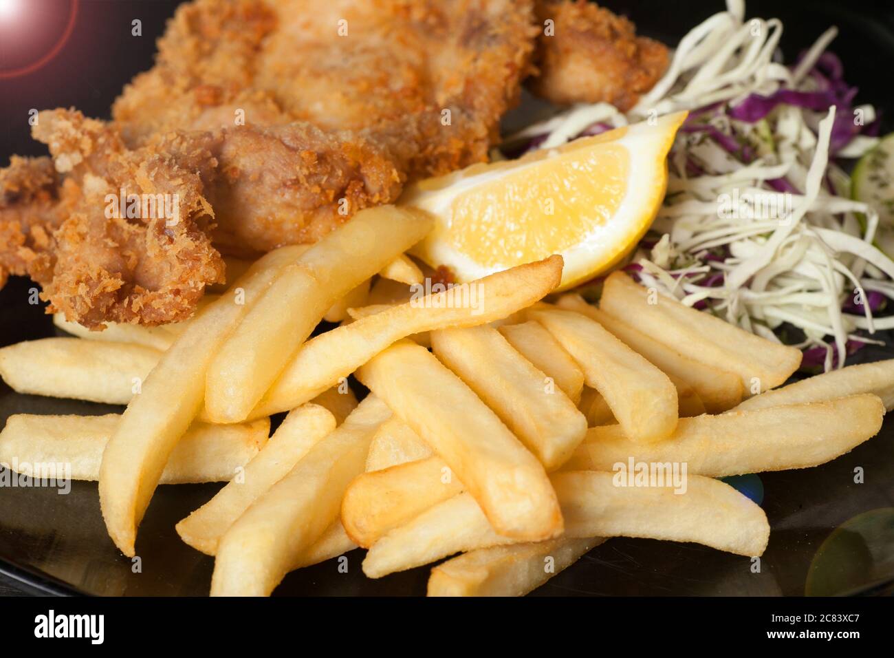 Nahaufnahme eines Teller mit Lebensmitteln, die gebratenes Huhn, Kartoffeln und Salate haben. Stockfoto