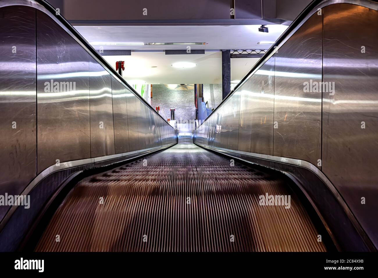 Rolltreppe in der Community Mall, U-Bahn-Station, Einkaufszentrum oder Kaufhaus. Bewegliche Treppe. Neonlicht, Moderner Rolltreppe Stockfoto