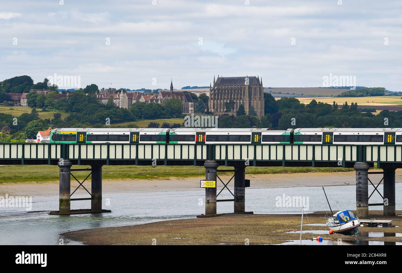 Der Zug der südlichen Eisenbahn überquert den Fluss Adur bei Shoreham-by-Sea mit Lancing College in der Ferne Stockfoto
