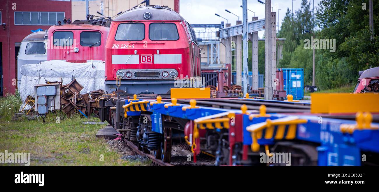 16. Juli 2020, Mecklenburg-Vorpommern, Mukran: Alte Lokomotiven und Waggons stehen auf dem Freigelände vor der Reparaturwerkstatt der Baltic Port Services GmbH (BPS). In der Werkstatt, die 1986 von der Deutschen Reichsbahn eröffnet wurde, wurden Schienenfahrzeuge, die von der Eisenbahnfähre kommen, von der 1520 Millimeter breiten russischen Breitspur auf die im übrigen Europa übliche Standardspur umgemessen. Die Werkstatt, die 2014 von der heutigen Firma Enon mit Sitz in Putlitz, Brandenburg, übernommen wurde, saniert alte Lokomotiven und Eisenbahnwaggons für den Einsatz durch private Bahnunternehmen. P Stockfoto