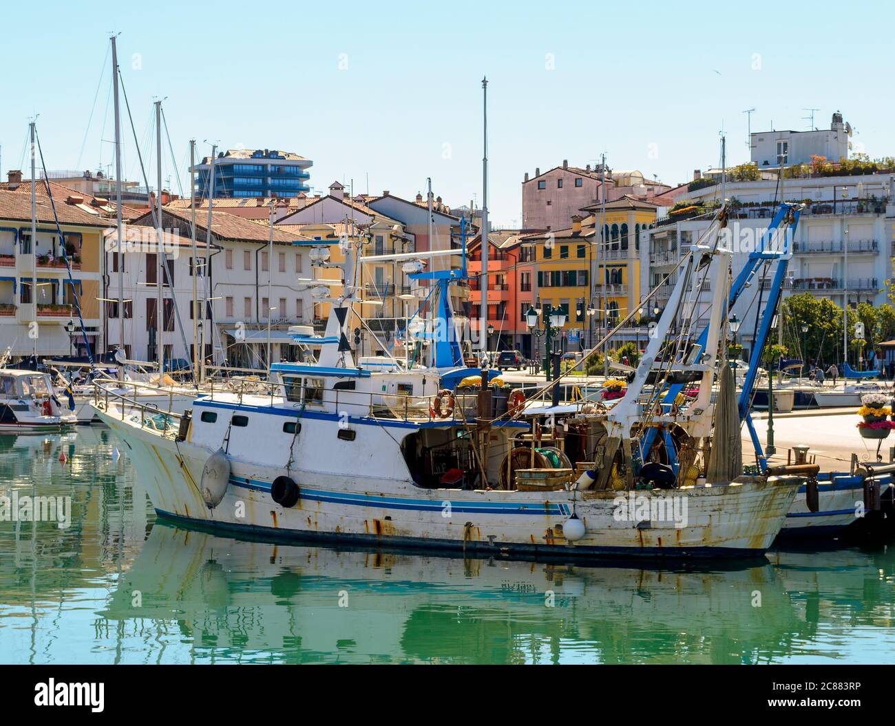 Fischerboot im Hafen Porto vecchio vor den Stadthäusern in Grado, Italien Stockfoto