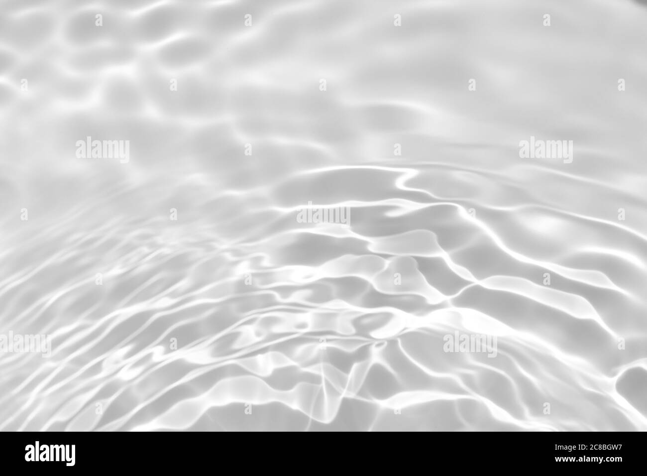 Nahaufnahme von entsättigt transparent klar ruhigen Wasser Oberflächenstruktur mit Spritzern und Blasen. Trendige abstrakte Natur Hintergrund. Weiß-graues Wasser wav Stockfoto