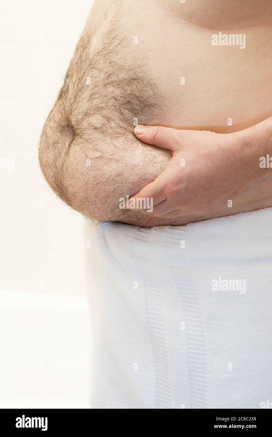 Barchested man with hands on Belly mid section Stockfoto