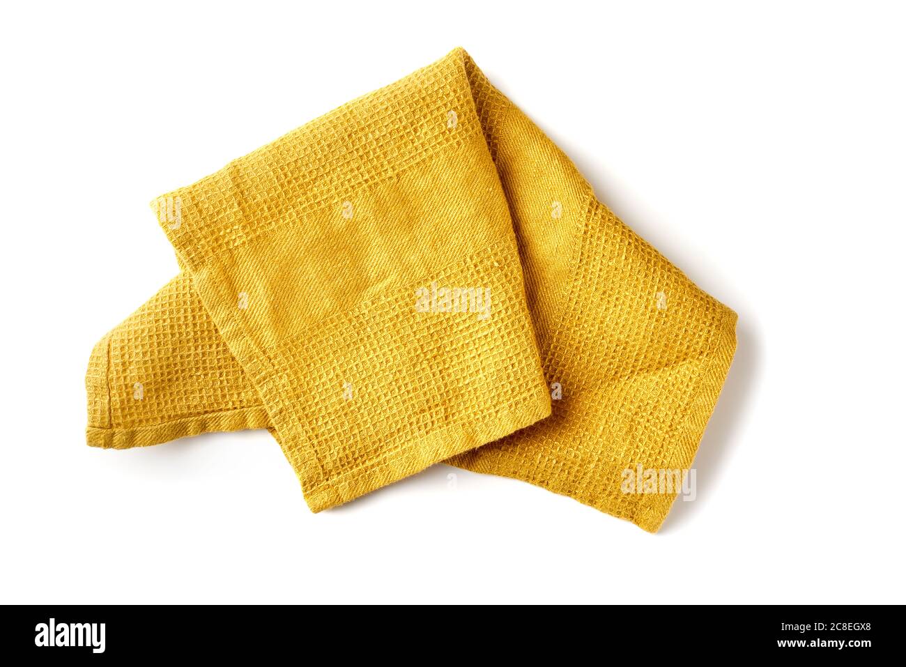 Gelbverkrümmte Textilserviette auf weiß Stockfoto