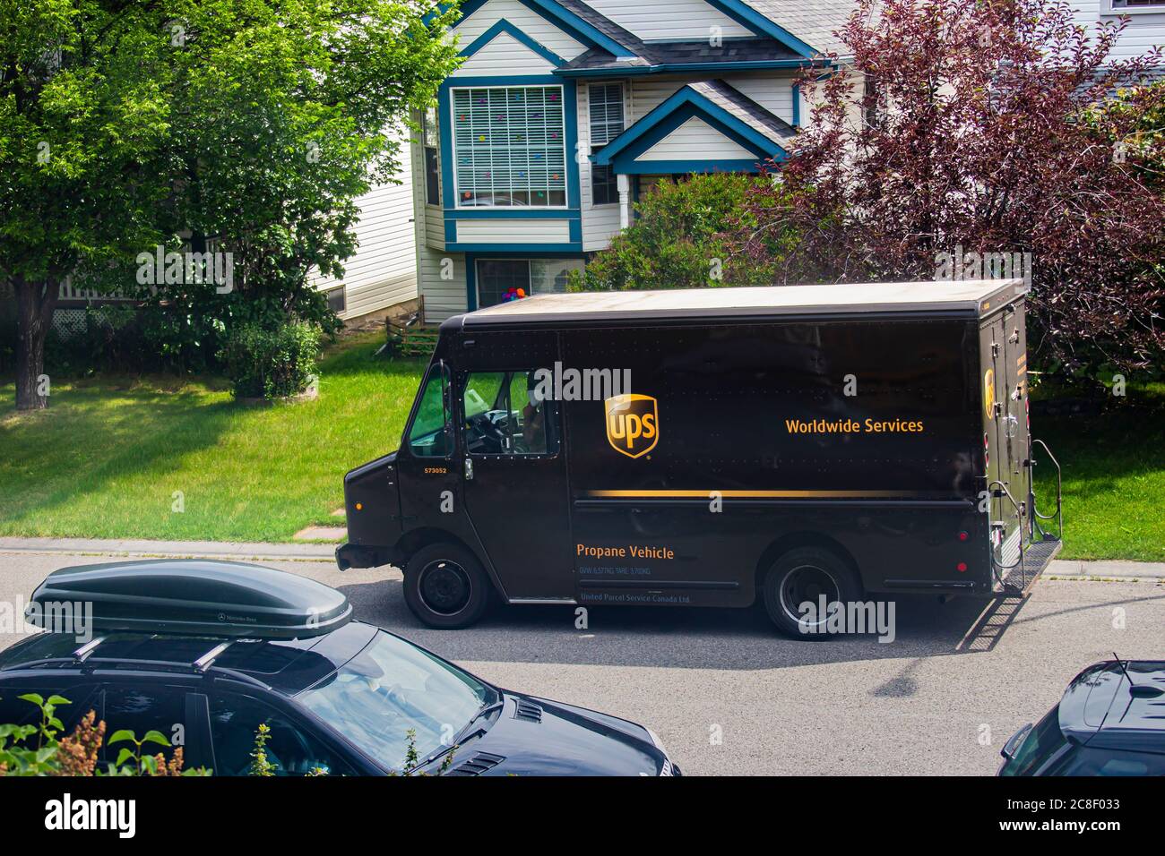 Calgary, Alberta, Kanada. Juli 23, 2020. UPS Lieferung LKW an der Seite der Straße vor dem Wohngebiet geparkt. Mit Menschen im Fahrzeug Stockfoto