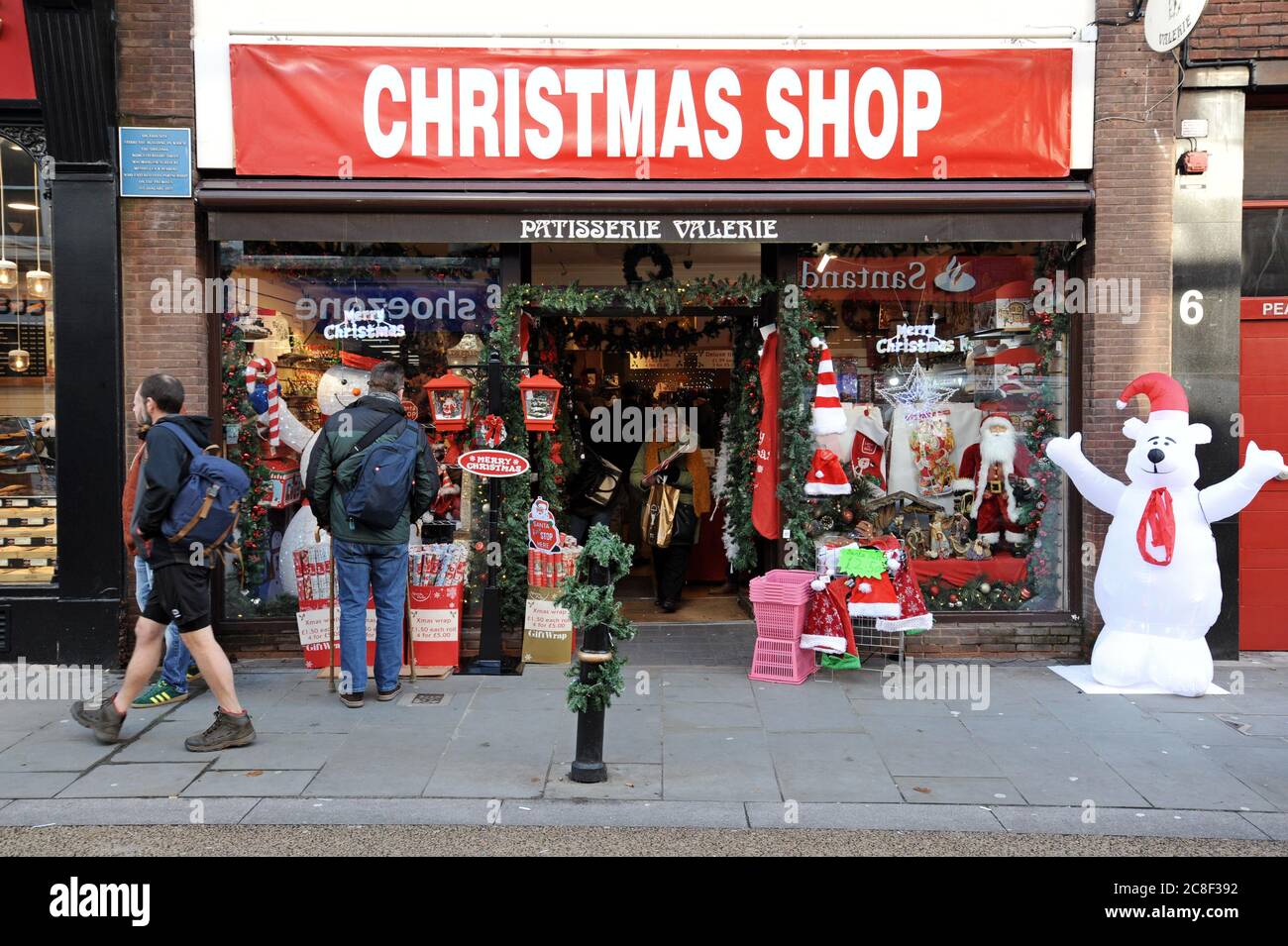 Einkäufer, die in einem Pop-up-weihnachtsgeschäft in einem ehemaligen Patisserie Valerie Bäckerei-Geschäft stöbern Stockfoto