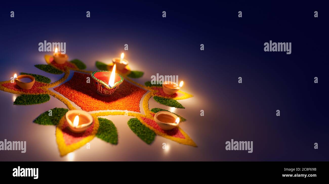 Happy Diwali, Diya Öllampen auf bunten Rrangoli mit Kopierraum beleuchtet Stockfoto
