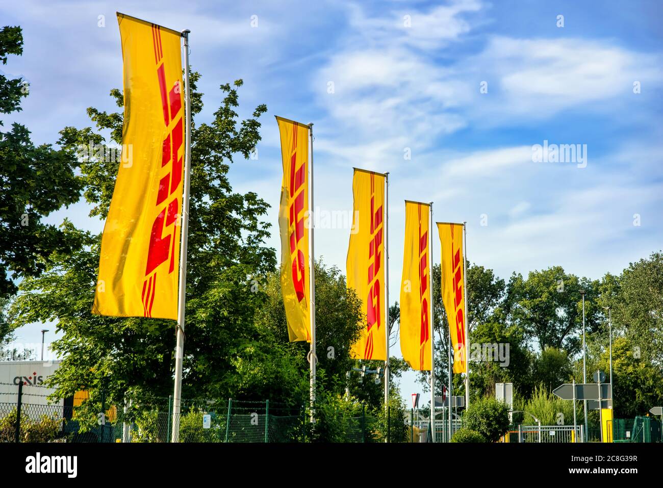 Flaggen mit DHL-Logo vor dem Paketverteilerzentrum der Deutschen Post DHL Group in Berlin. Stockfoto