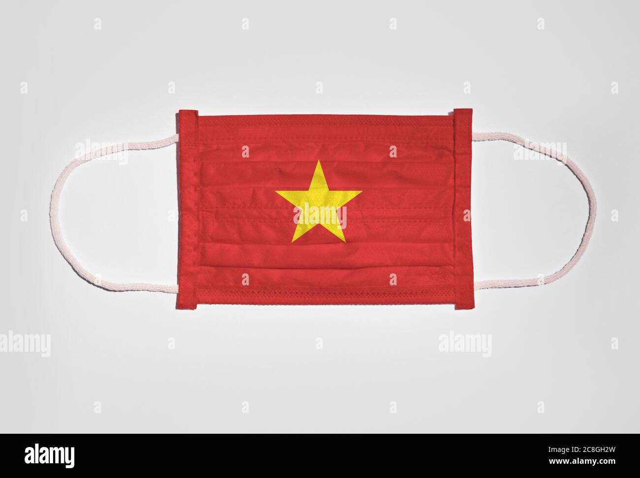 Symbolbild Corona Krise, Mundschutz, Atemmaske, Mund- und Nasenschutz mit  Flagge von Vietnam, weißer Hintergrund Stockfotografie - Alamy