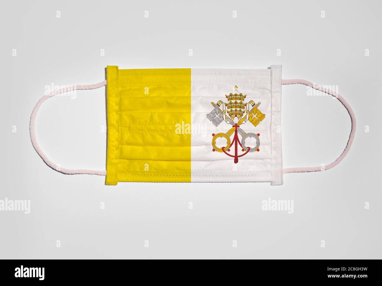 Symbolbild Corona Krise, Mundschutz, Atemmaske, Mund- und Nasenschutz mit Flagge der Vatikanstadt, weißer Hintergrund Stockfoto