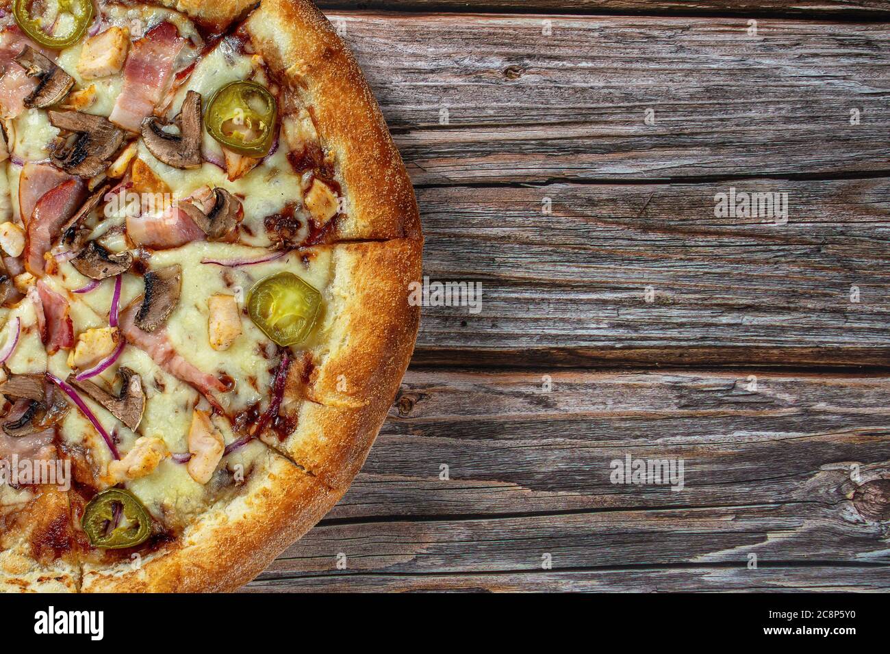 Pizza mit Grillhähnchen, Schinken und Jalapeno Pfeffer Stockfoto
