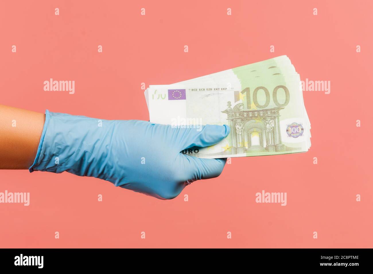 Profil Seitenansicht Nahaufnahme der menschlichen Hand in blauen OP-Handschuhen, die den Fan der Europäischen Union Euro Money in der Hand halten und zeigen Stockfoto