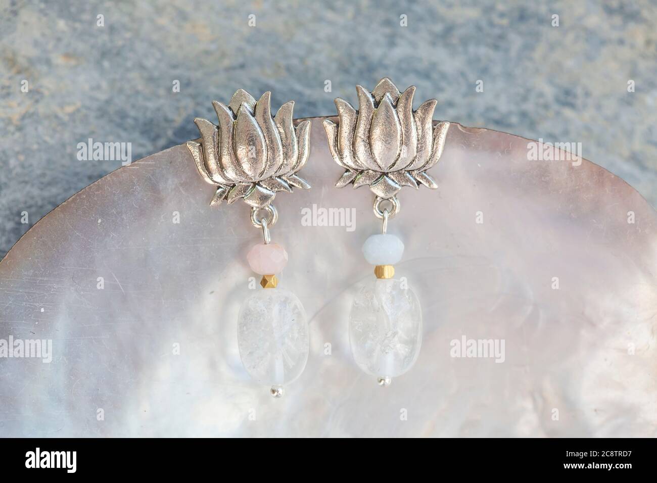 Lotus Form Kristall Quarz fazeled Morganit Perle weibliche Ohrringe auf neutralem Hintergrund Stockfoto