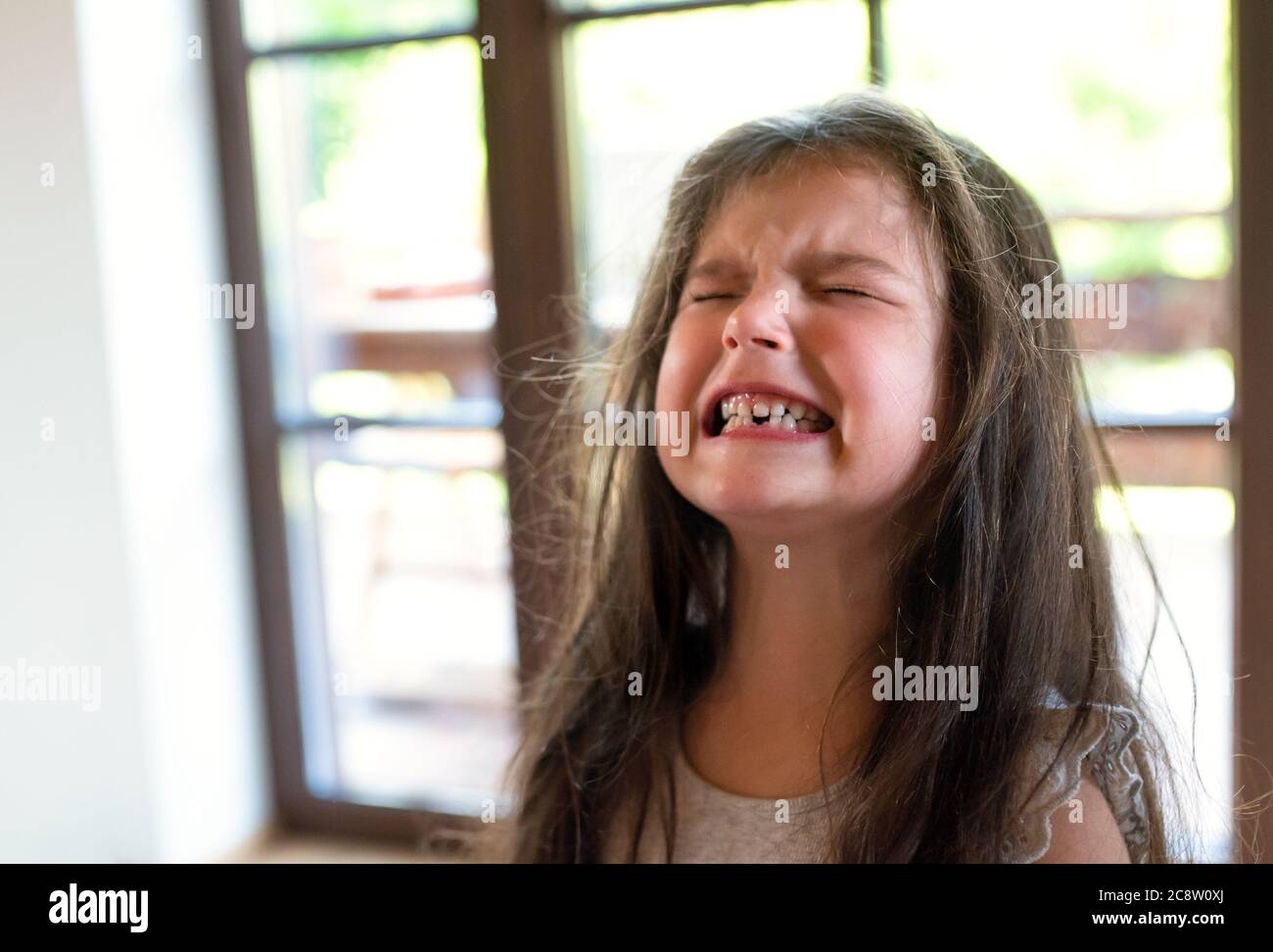 Portrait von wütend kleinen Mädchen drinnen, weinen. Stockfoto
