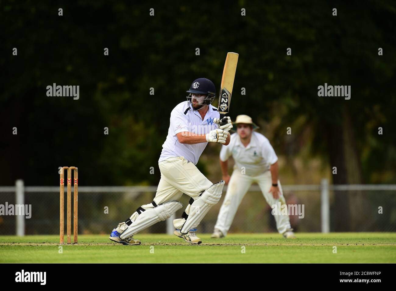 Ein Cricketspieler entscheidet, ob er während eines Cricket-Spiels in Victoria, Australien, als Feldspieler zuschaut Stockfoto