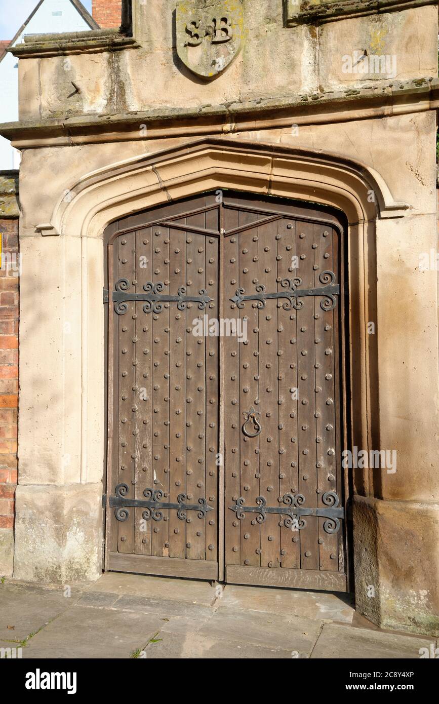 Alte hölzerne Eingangstür mit Steinumrandung. Stockfoto