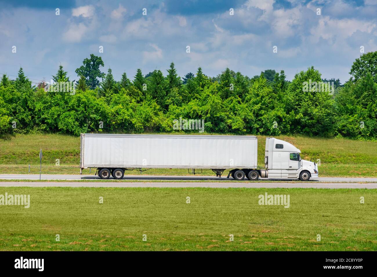 Horizontale Seitenansicht eines weißen Traktorenwagens mit einem leeren Anhänger, der große Kopiefläche bilden würde. Stockfoto