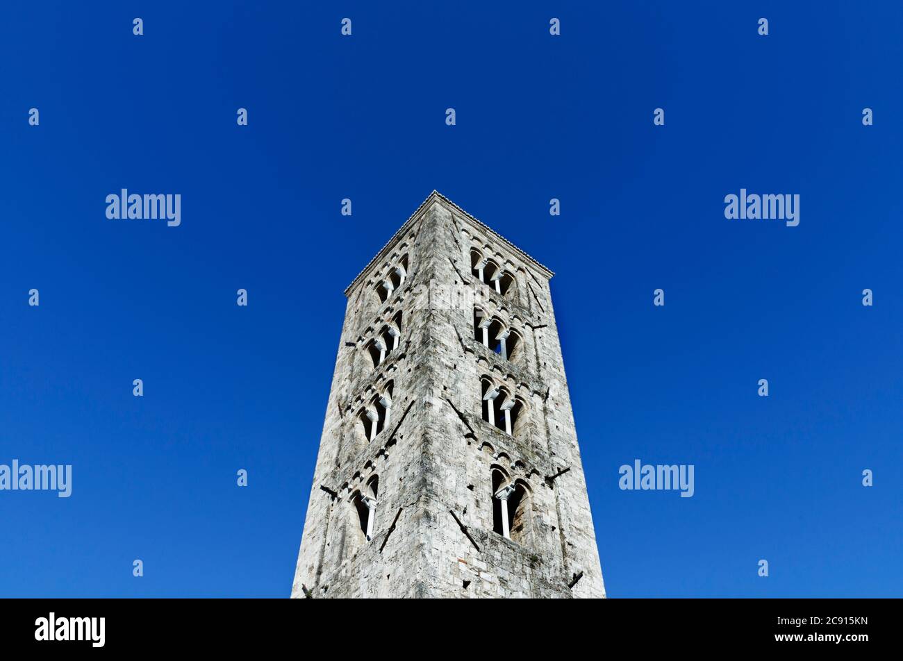 Glockenturm der Kathedrale von Anagni gegen blauen Himmel, schöner quadratischer Turm mit Mullionfenstern und Dreifach Stockfoto