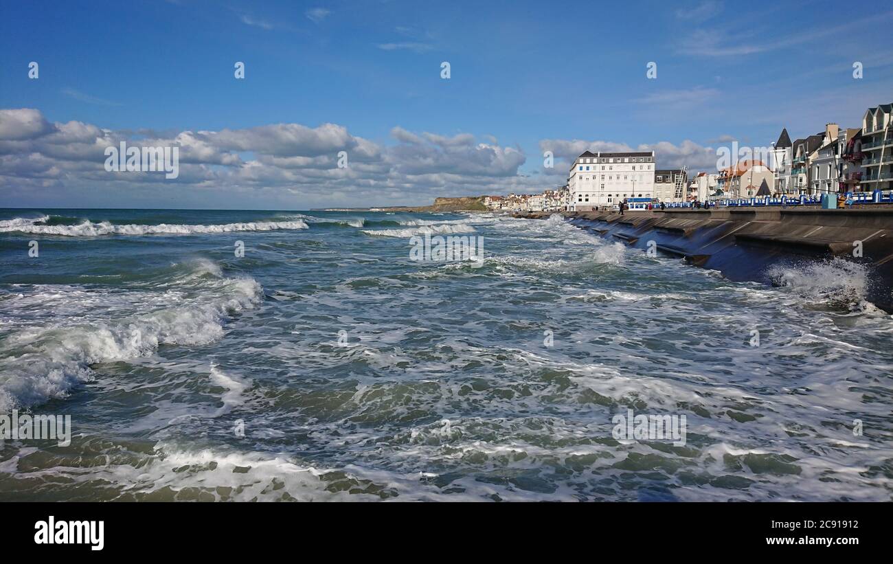 Die Flut ist in und die Wellen schlagen die Meeresmauer in diesem Foto an einem sonnigen Herbsttag in Wimereux, Frankreich aufgenommen Stockfoto