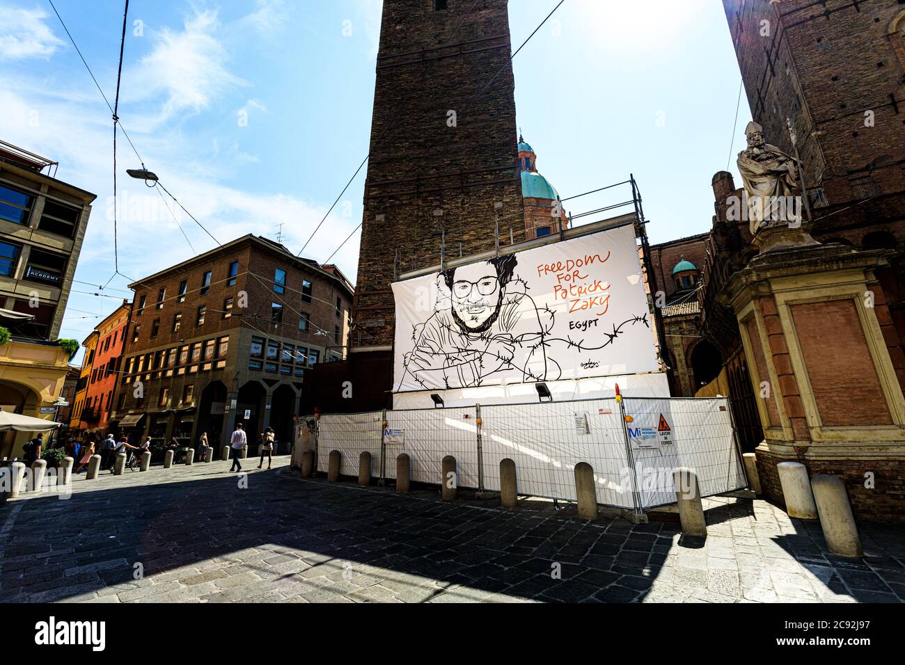 Bologna, Italien. Juli 2020. Eine große Plakatwand unter den zwei Türmen trägt nun Patrick Zaki's Gesicht (das Bild wurde von dem Künstler Gianluca Costantini konzipiert), der seine Freiheit von einem ägyptischen Gefängnis am 28. Juli 2020 in Bologna, Italien, fordert. Patrick George Zaki ist ein 28-jähriger ägyptischer Menschenrechtsaktivist, wurde auf dem Internationalen Flughafen Kairo entführt, als er aus Bologna (Italien) kam, wo er derzeit für seinen MD an der Universität von Bologna studiert und ohne wirkliche Anschuldigungen gefoltert und mit Elektroschocks ermordet wurde. Kredit: Massimiliano Donati/Alamy Live Nachrichten Stockfoto