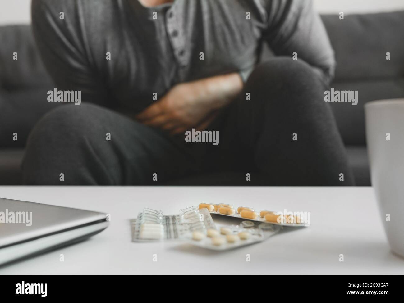 Mann, der zu Hause an Magenschmerzen leidet. Stockfoto