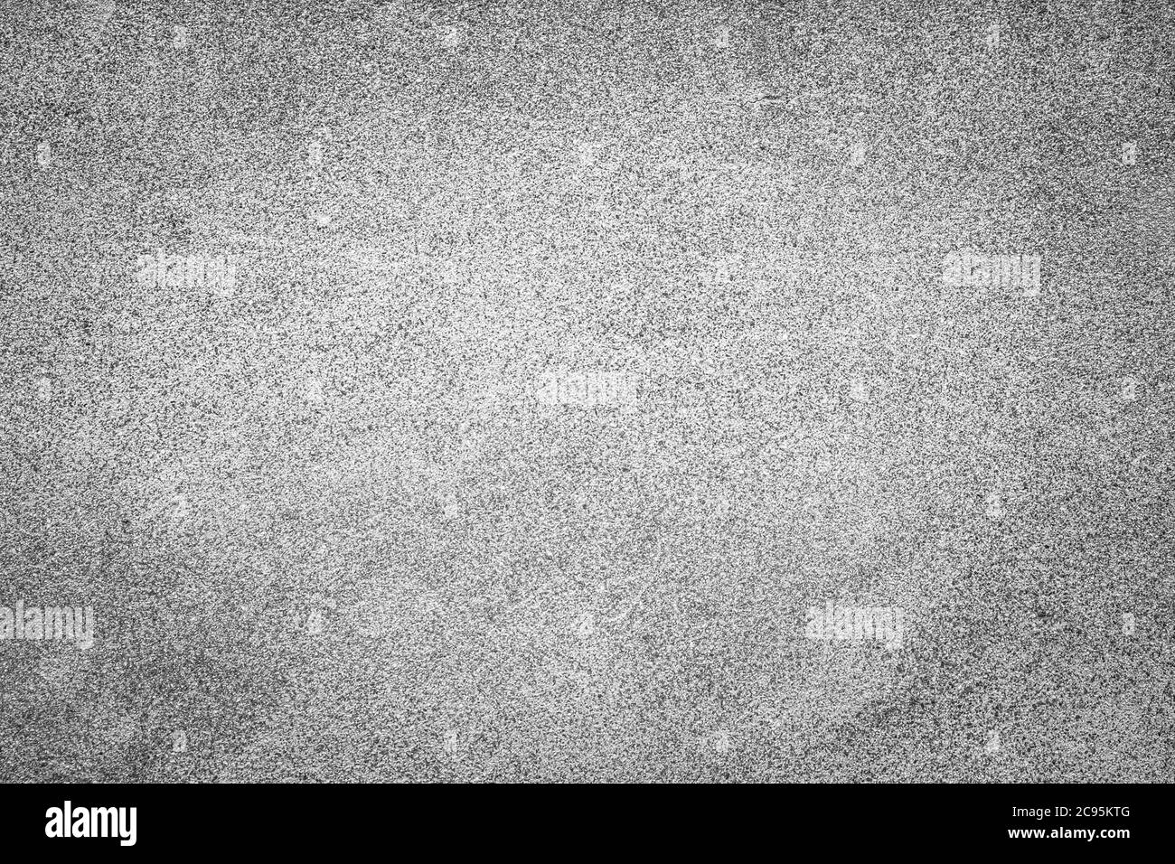 Grunge Betonhintergrund mit einer Vignette und einer porösen Textur In Form von kleinen Punkten, die Granit ähneln Stockfoto