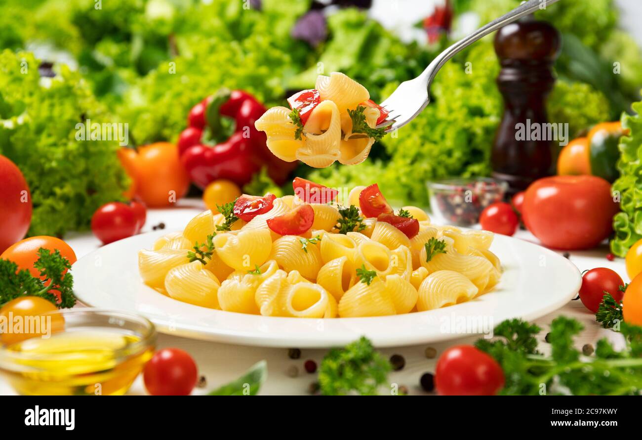 Teller italienische Pasta, Rohr rigate auf Gabel mit Tomaten und Basilikum Stockfoto