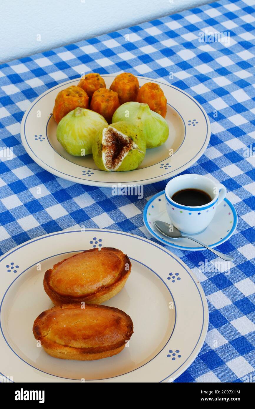 Frühstück im Salento, mit typischen Produkten der süditalienischen Tradition: Kaktusbirnen, Feigen und Pasticciotto mit Sahne auf Keramikplatten und w Stockfoto