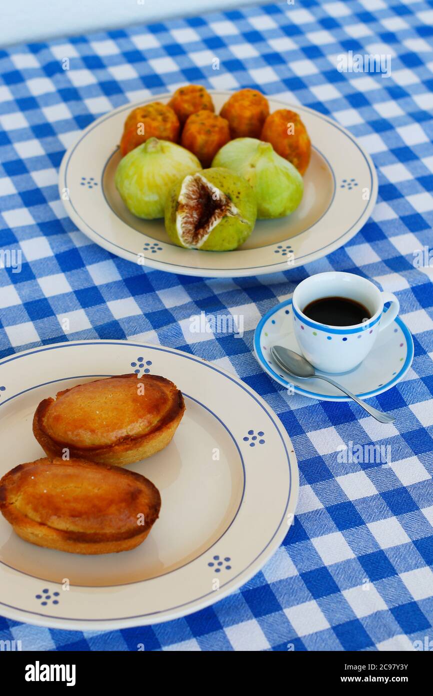 Frühstück im Salento, mit typischen Produkten der süditalienischen Tradition: Kaktusbirnen, Feigen und Pasticciotto mit Sahne auf Keramikplatten und w Stockfoto