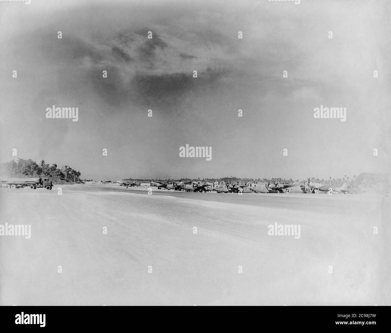 Konsolidierte B-24 Liberator Nummern 1651, 1673 und 1650 (plus ein weiterer) warten auf Betankung in Northfield, Guam. Vier Douglas C-47 Skytrain Truppentransporte sind in der Ferne geparkt. Zum 75. Jahrestag des V-J Day hat die Consoli Collection vier Fotoessays von U.S. Navy LT. (j.g.) veröffentlicht. Joseph J. Consoli. Die Fotos wurden zwischen Juli und Dezember 1945 auf den Marianen aufgenommen. Sie dokumentieren das Leben der US-Marine vor und nach der japanischen Kapitulation. Stockfoto