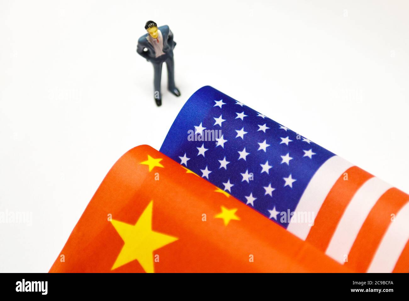Fuyang, China. Juli 2020. In dieser Abbildung steht eine kleine menschliche Figur neben einer chinesischen Flagge und einer amerikanischen Flagge, die zusammen platziert sind.in den letzten Tagen hat der diplomatische Herabstufung des gegenseitigen Rückzugs der Konsulate zwischen China und den Vereinigten Staaten die Beziehungen zwischen China und den USA angespannt. Kredit: SOPA Images Limited/Alamy Live Nachrichten Stockfoto