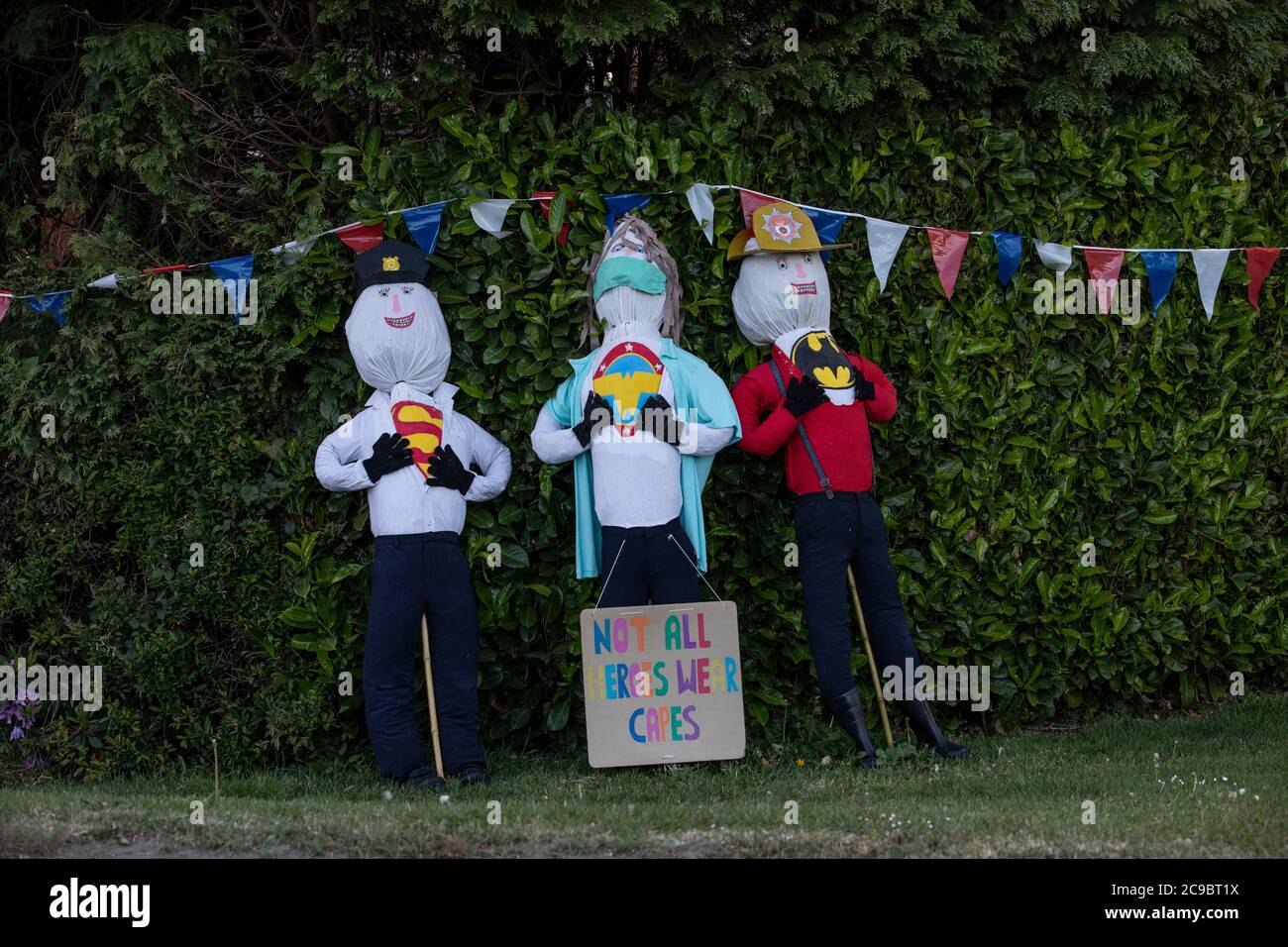 Hausgemachte Schaufensterpuppen, die "Schlüsselarbeiter" darstellen, die entlang der Straßenseite im Dorf Four Marks während der Coronavirus-Sperre, England, Vereinigtes Königreich, aufgestellt wurden Stockfoto