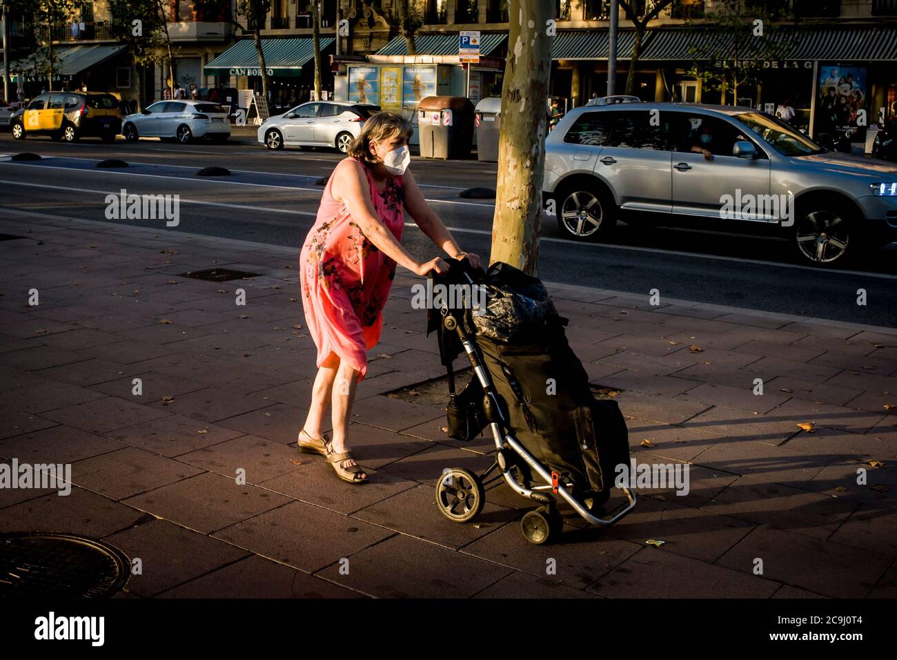 31. Juli 2020, Barcelona, Katalonien, Spanien: Eine Frau mit Gesichtsmaske schiebt den Einkaufswagen in Barcelonas maritimem Viertel La Barceloneta. Die spanische Wirtschaft verbucht aufgrund der Blockierung des Coronavirus einen historischen Rückgang um 18,5 Prozent pro Quartal. Großbritannien, Frankreich und Deutschland raten von nicht-wesentlichen Reisen nach Spanien wegen steigender Coronavirus-Fälle, ein Rat, der die Tourismuswirtschaft des Landes ernsthaft beeinträchtigt.Quelle:Jordi Boixareu/Alamy Live News Stockfoto
