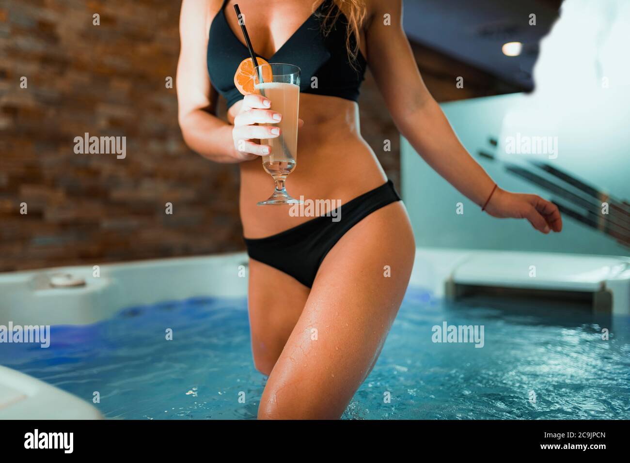Frau genießt Whirlpool in einem Spa. Limonade trinken und entspannen. Stockfoto