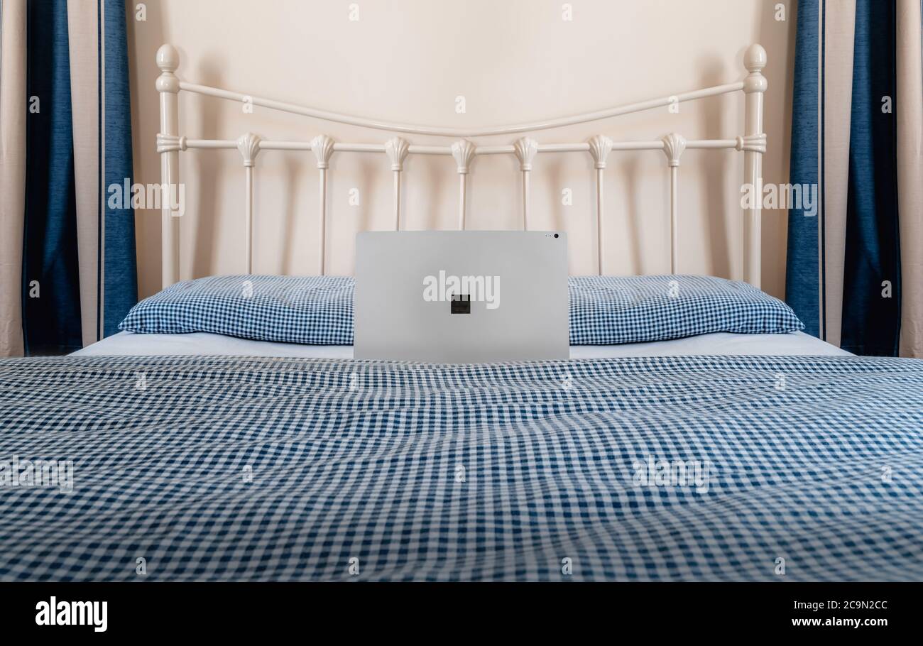 WFH - Arbeit von zu Hause mit Laptop auf Bett 1 Stockfoto