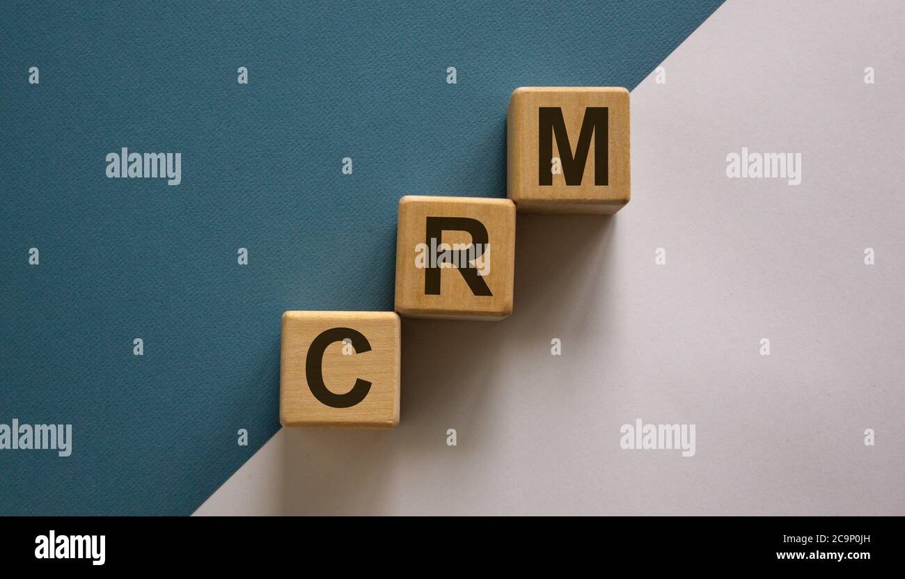 Holzwürfel mit Wort 'CRM' Stapeln als Treppenstufe auf Papier blau und weiß Hintergrund, kopieren Raum. Geschäftskonzept. Stockfoto