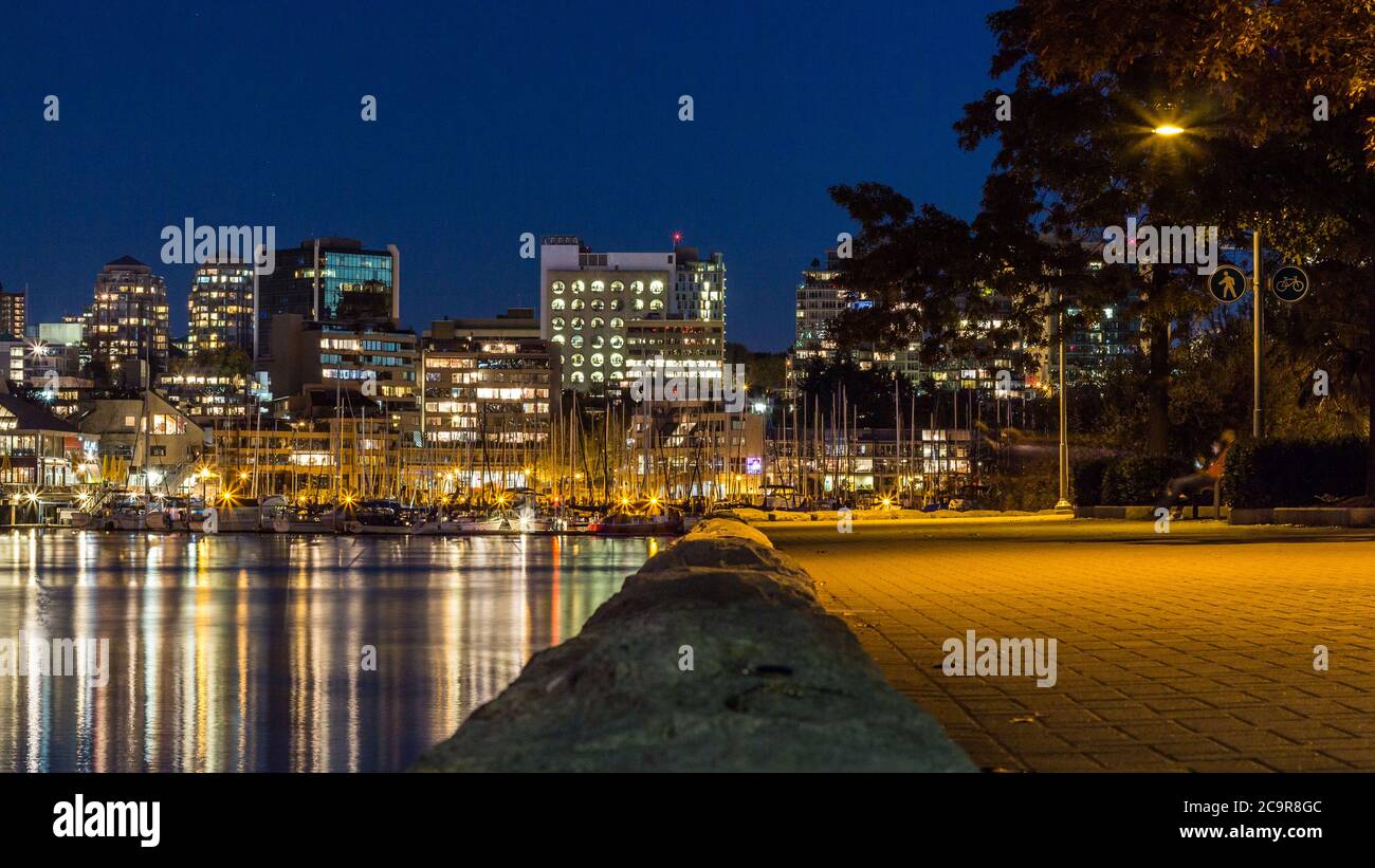Yachten geparkt im Hafen in Vancouver mit der Stadt Nachts im Hintergrund Stockfoto