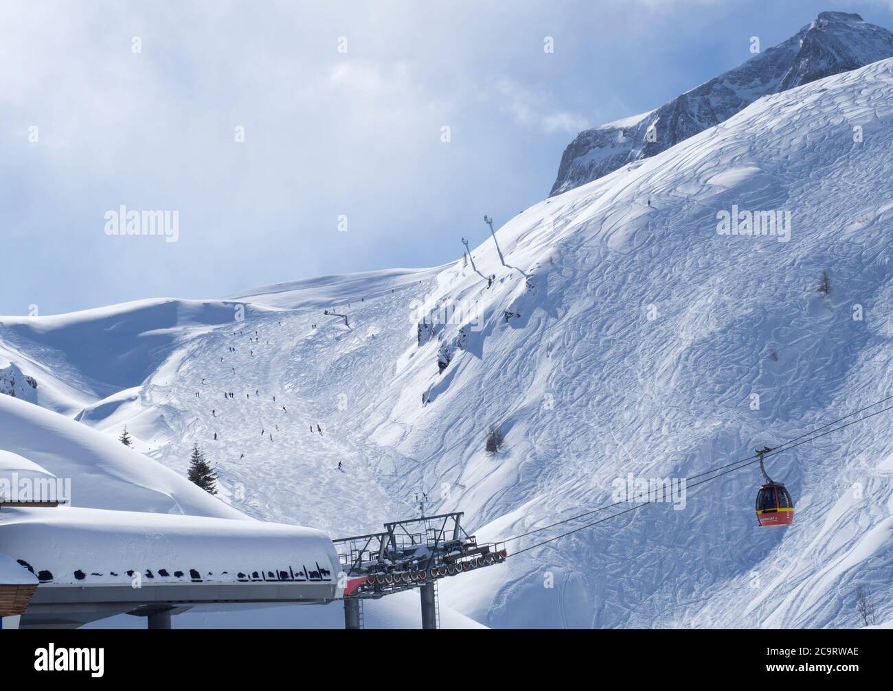 KAPRUN, ÖSTERREICH, 12. März 2019: Schneebedeckte Pisten mit roten Bergbahnen und Sesselliften mit kostenlosen Fahrten und Pisten im Bergskigebiet Kaprun, Na Stockfoto