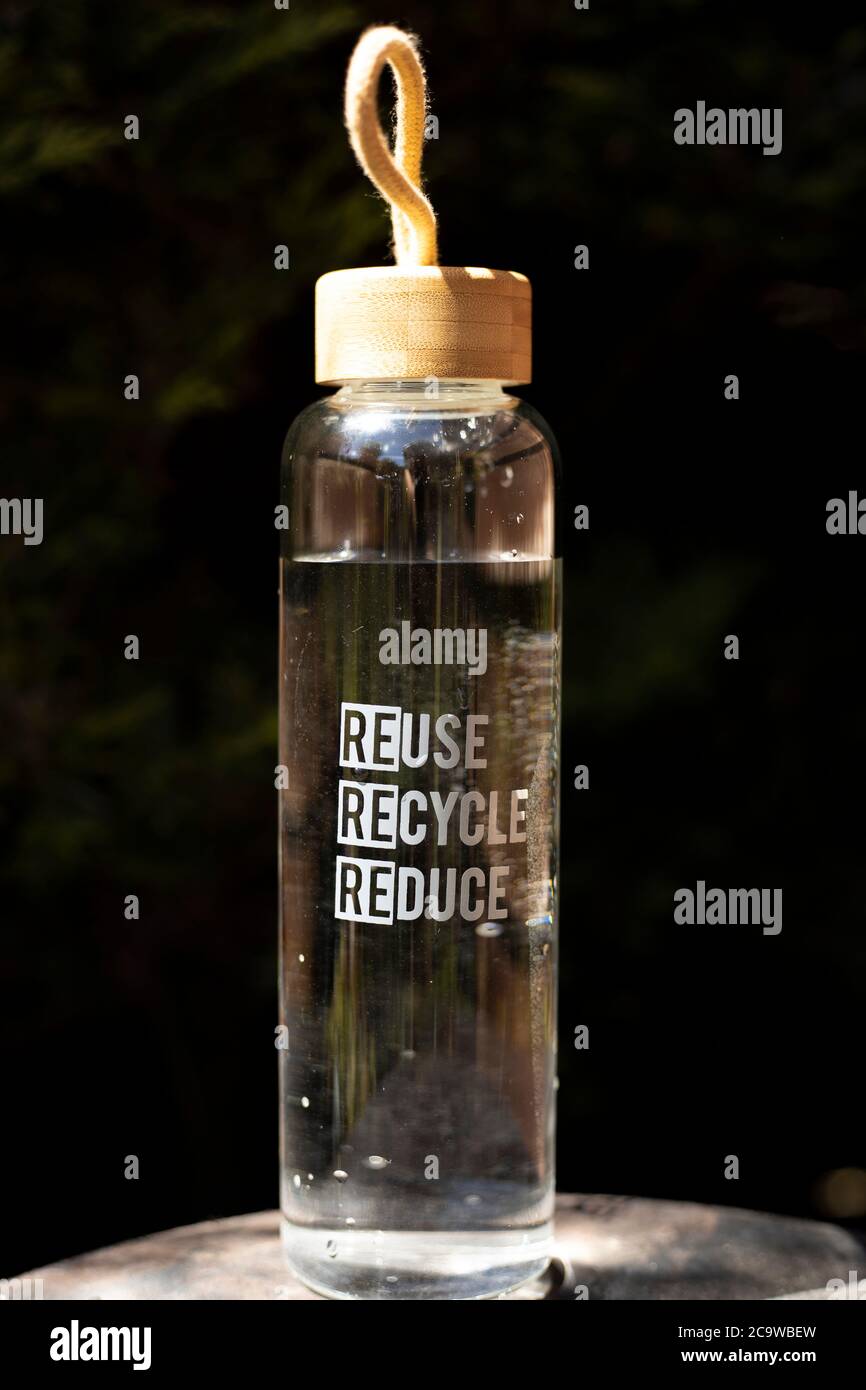 Wiederverwenden Recycling Reduzieren Sie gemusterte Glas-Trinkflasche mit einem Bambusdeckel Stockfoto