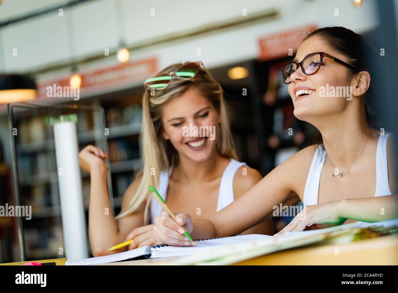 Gruppe glücklicher Studenten, die gemeinsam an der Universitätsbibliothek studieren Stockfoto