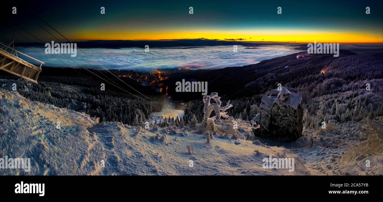 Sonnenaufgang und Inversion am Jested Berg in der Nähe der Stadt Liberec, Tschechien, Schnee und Winter und Blick auf die Seilbahn. Stockfoto