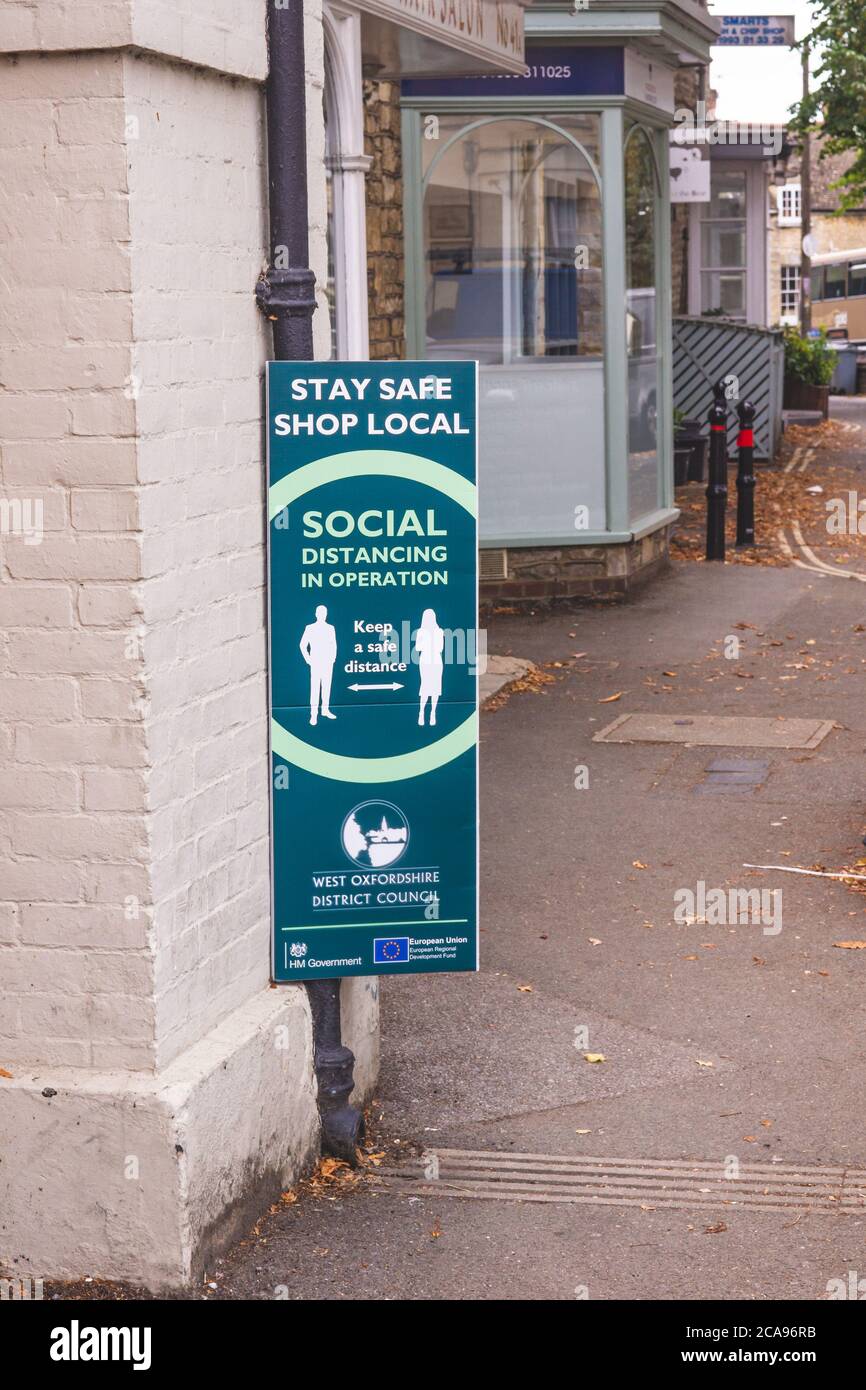 Schilder, die soziale Distanzierungsregeln in Woodstock Village Center, West Oxfordshire, Großbritannien erklären Stockfoto