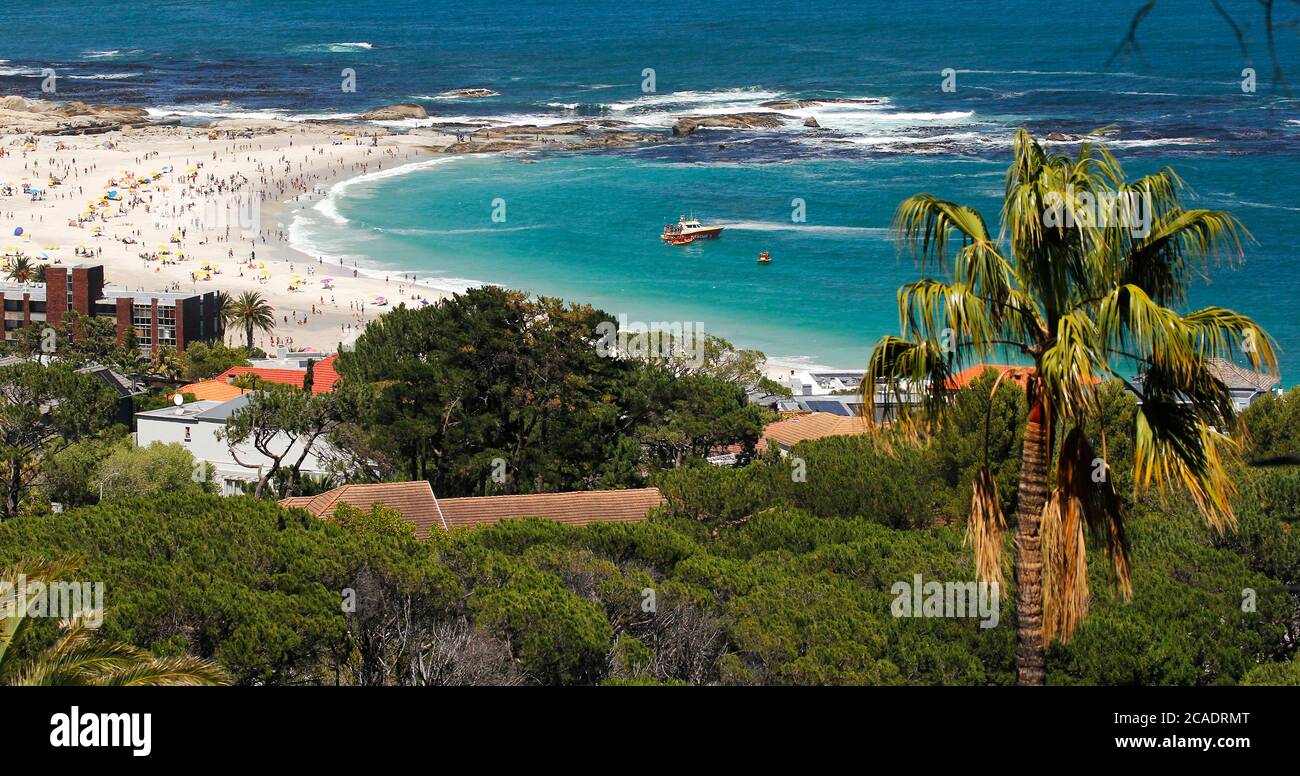 Ein verkürzter Blick auf Kapstadts beliebtesten Strand, Camps Bay Beach. Gelegen unter den Twelve Apostles Mountains hinter dem Tafelberg. Stockfoto