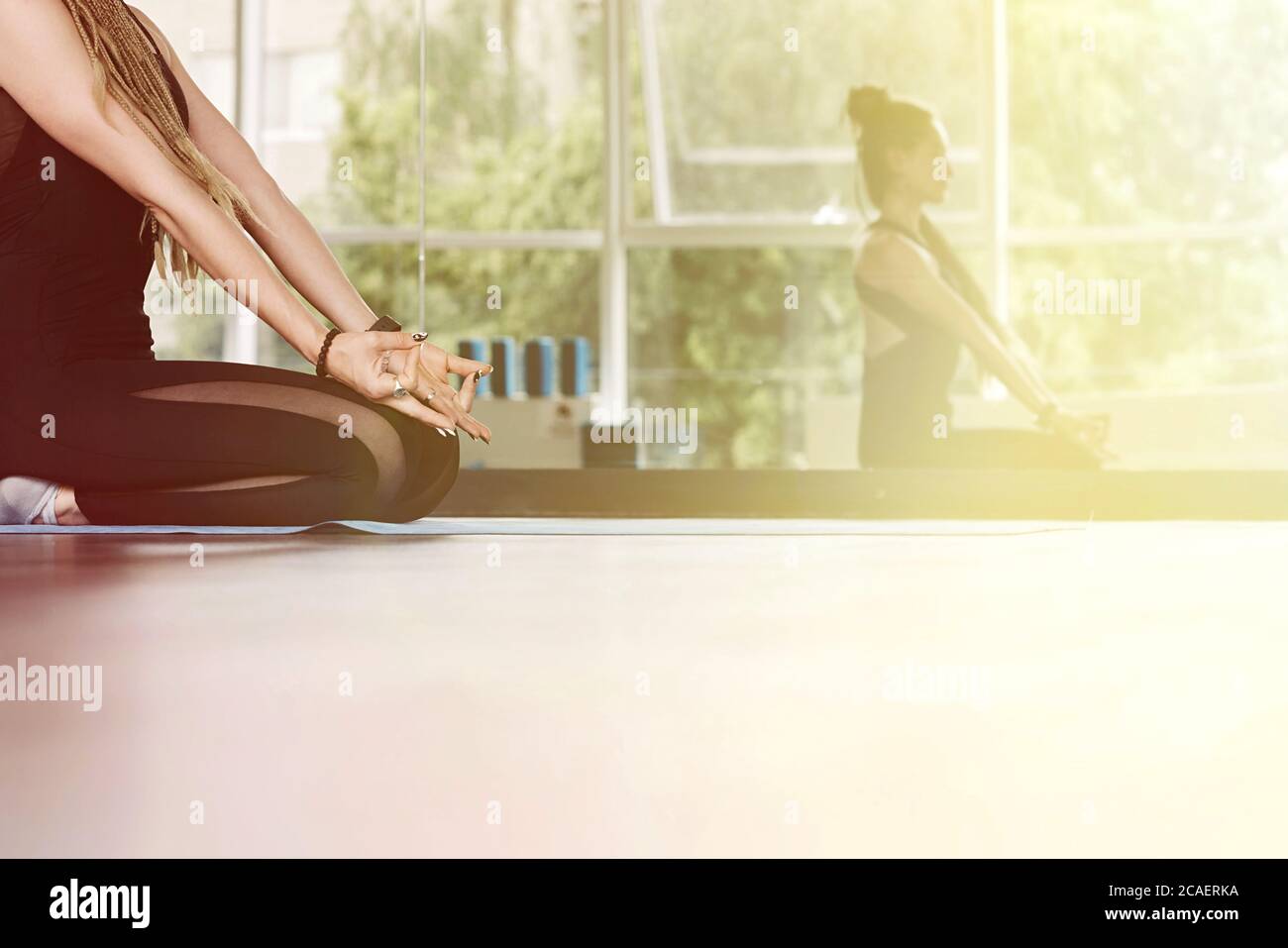 Junge athletische Frau sitzt mit einer Mudra-Geste. Yoga-Unterricht, Atmung, Meditation. Nahaufnahme. Stockfoto