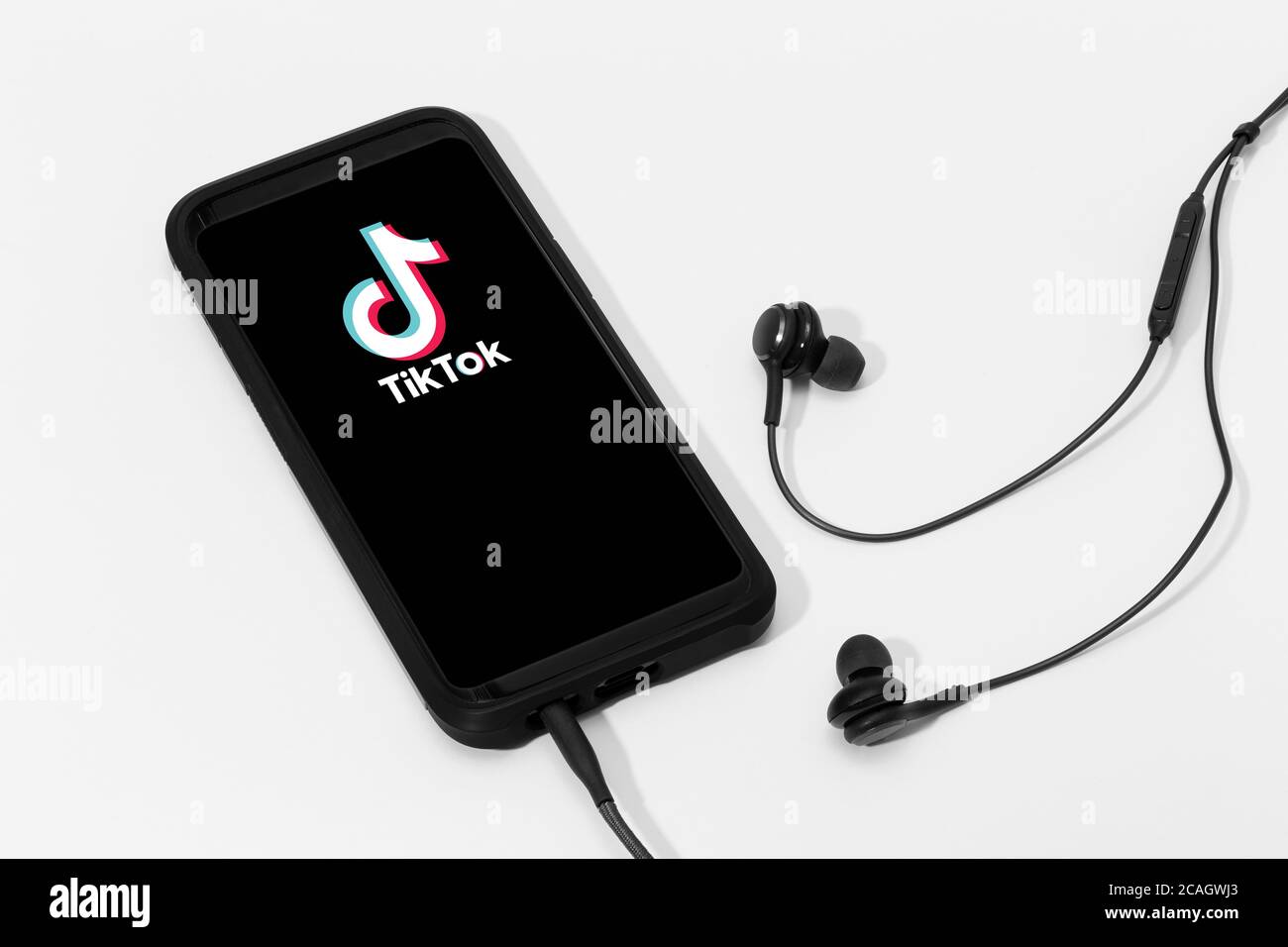 Galicia, Spanien; 25. märz 2020 : Kopfhörer und Smartphone-Bildschirm mit Tik Tok-Logo Stockfoto