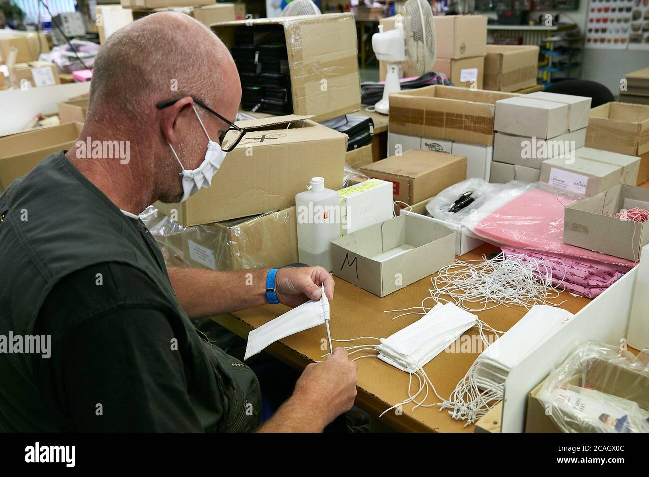 11.06.2020, Eberswalde, Brandenburg, Deutschland - Herstellung von Mund-Nase-Schutzmasken bei der Firma Thorka. Ein Mitarbeiter sitzt an einem Tisch Stockfoto