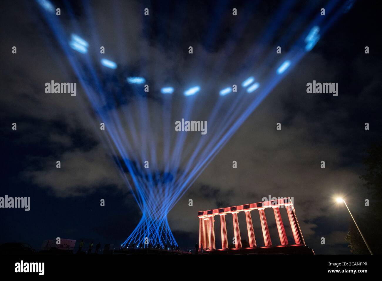 Der Himmel über Calton Hill, Edinburgh, wird von My Light Shines On, einer Außenlichtinstallation für das Edinburgh International Festival 2020, erleuchtet. Veranstaltungsorte in der ganzen Stadt, darunter Edinburgh Castle, Festival Theatre und Usher Hall, nehmen an der Veranstaltung Teil, die das Eröffnungswochenende der Festivalsaison 2020 markiert. Stockfoto