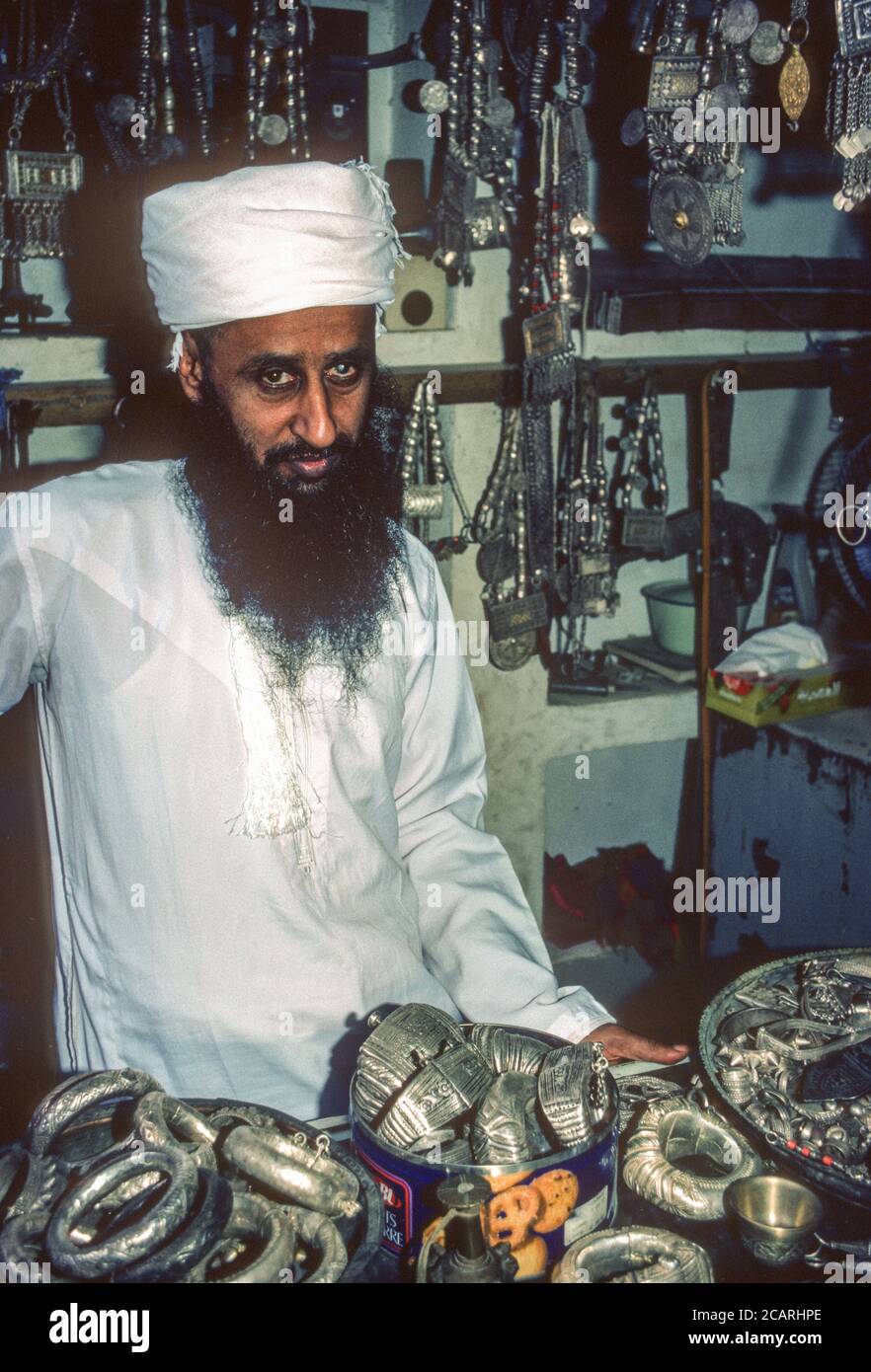 Nizwa, Oman. Omanischer Anbieter von Metallschmuck, Halsketten und Anklets. Stockfoto