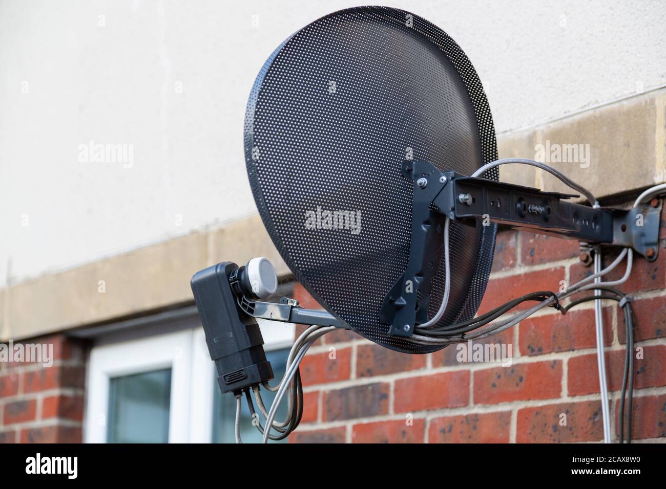 Eine Nahaufnahme einer Satellitenschüssel auf der Seite Eines Hauses Stockfoto