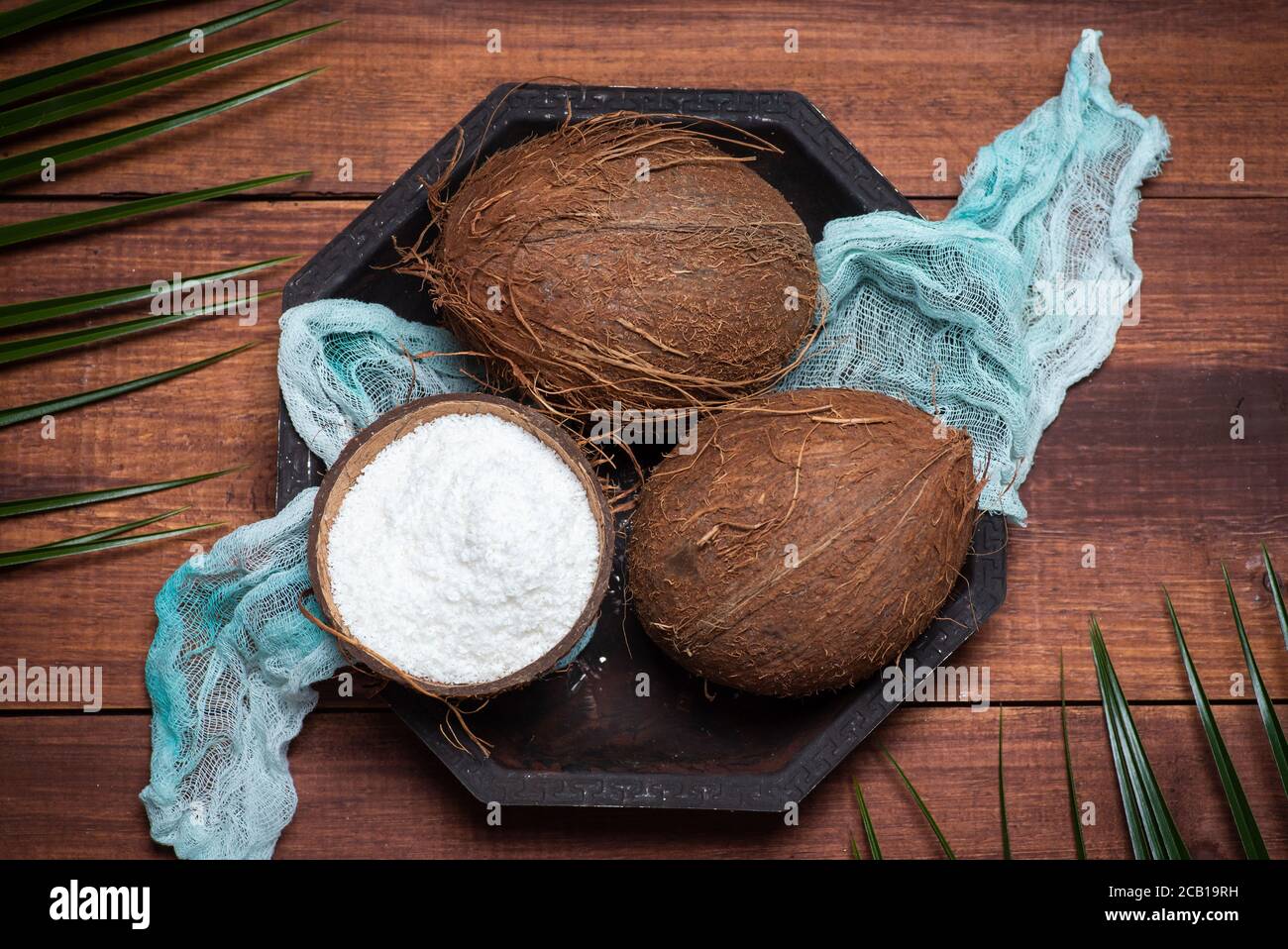 Öffnen und geriebenen Kokosnussfrucht auf einer hölzernen Tischplatte Anzeigen Stockfoto